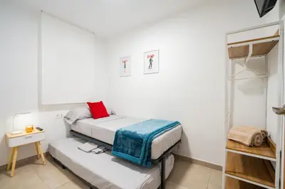 a small bedroom with two beds and a table at Home365 · Barberá del Vallés · Barcelona in Barbera del Valles