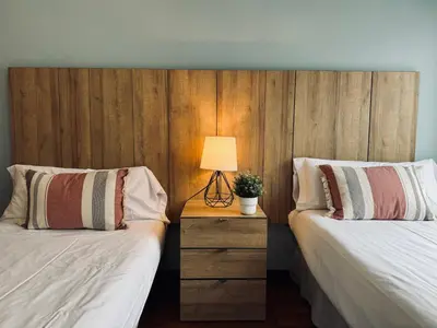 a bedroom with two beds and a lamp on a night stand at Sweet BCN Sagrada Familia in Barcelona