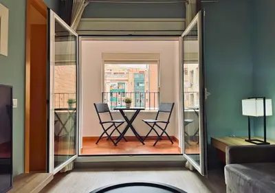 a dining room with a table and chairs on a balcony at Sweet BCN Sagrada Familia in Barcelona