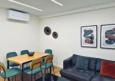 a living room with a couch and a table and chairs at Sweet BCN Laforja in Barcelona