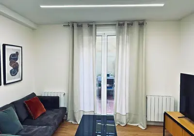 a living room with a couch and a window at Sweet BCN Laforja in Barcelona