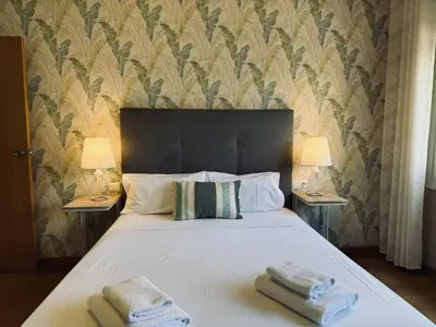 a bedroom with a large bed with two towels on it at Sweet BCN Laforja in Barcelona