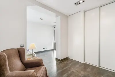 a living room with a couch and a chair at Beachside Bliss in Castelldefels