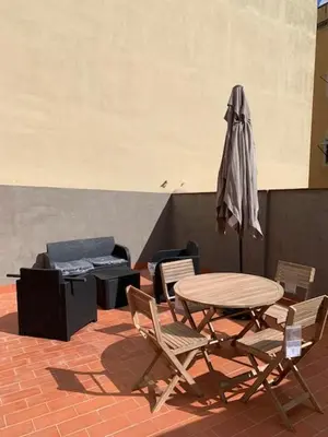 a table and chairs and an umbrella on a patio at Amazing flat in Barceloneta with private terrace 2-2 in Barcelona