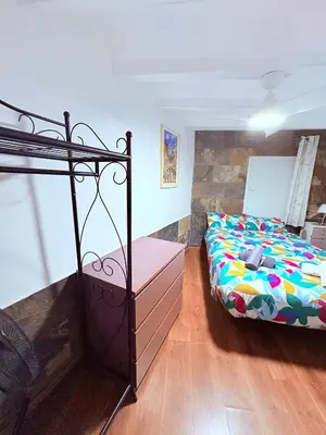 a bedroom with a bed with a colorful comforter at Stunning flat for 6 people 3 blocks from the beach plus welcome breakfast in Barcelona