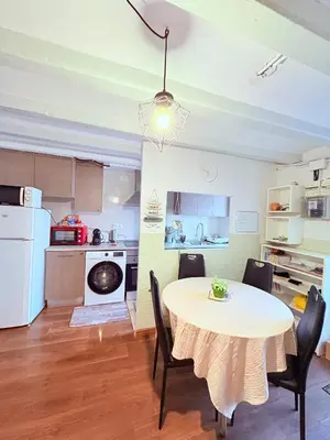 a kitchen and dining room with a table and chairs at Stunning flat for 6 people 3 blocks from the beach plus welcome breakfast in Barcelona