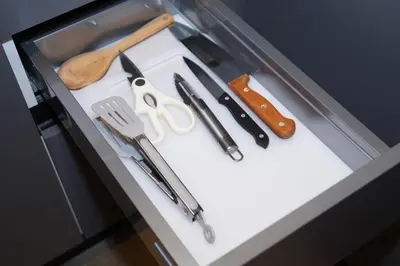 a drawer full of kitchen utensils on a counter at Monturiol Apartaments in Barcelona