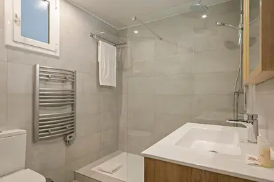 a white bathroom with a sink and a toilet at Habitat Apartments Pau in Barcelona