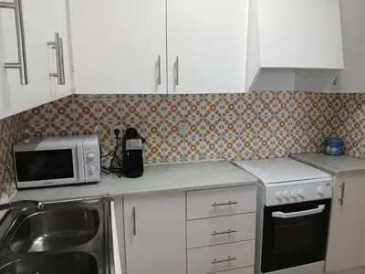 a kitchen with a microwave and a sink at Primera linea in Cunit