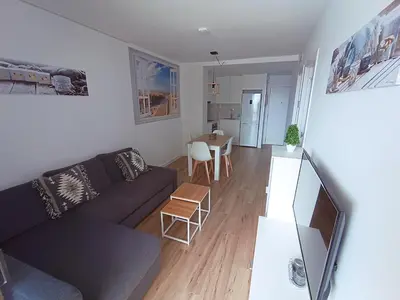 a living room with a couch and a table at Apartamento nuevo en Calella totalmente reformado con Parking privado in Calella