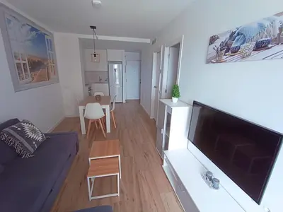 a living room with a large flat screen tv at Apartamento nuevo en Calella totalmente reformado con Parking privado in Calella