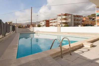 a swimming pool on the roof of a building at Sunset oceanfront in Castelldefels