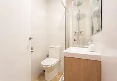 a bathroom with a toilet and a shower and a sink at Sunset oceanfront in Castelldefels