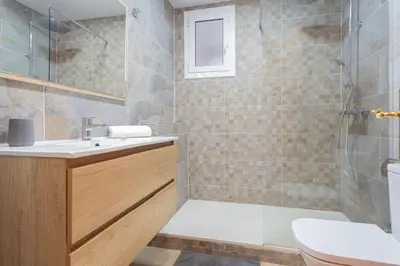 a bathroom with a sink and a shower and a toilet at Sunset oceanfront in Castelldefels