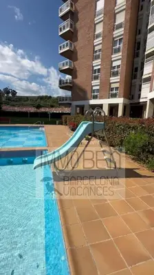 a swimming pool with a slide in front of a building at BV-SV-002-Mediterrani in Sant Andreu de Llavaneres