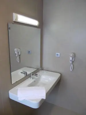 a bathroom with a white sink and a mirror at Hotel Mediterrani Express in Calella