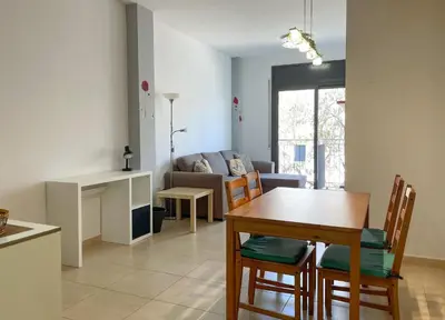 a kitchen and living room with a table and chairs at Apartment Marina in Vilanova i la Geltrú