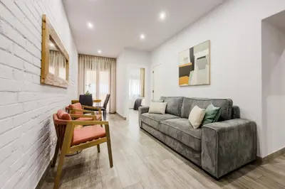 a living room with a couch and a table at Novus Homes Barcelona Santa Eulalia in Hospitalet de Llobregat