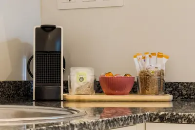 a kitchen counter with a coffee maker and a bowl of food at Novus Homes Barcelona Santa Eulalia in Hospitalet de Llobregat