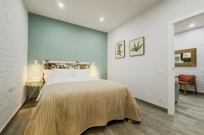 a bedroom with a large bed in a room at Novus Homes Barcelona Santa Eulalia in Hospitalet de Llobregat
