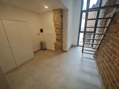 a room with a staircase and a brick wall at Antic Manresa Atico in Manresa