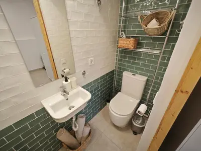 a bathroom with a white toilet and a sink at Antic Manresa Atico in Manresa