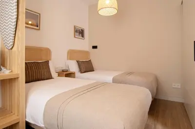 a room with two beds in a room at Stay U-nique Apartment Comte Güell in Barcelona