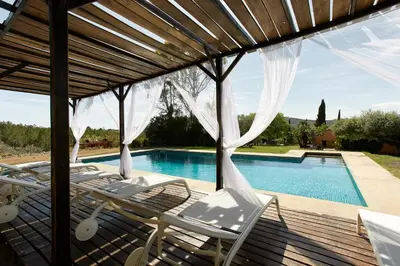 a patio with chairs and a swimming pool at Cal Mingo in Viladellops