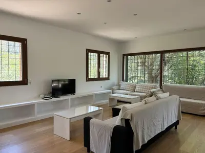 a living room with a couch and a tv at Vivenda de luxe a Barcelona in Sant Cugat del Vallès