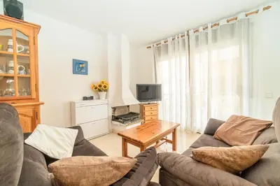 a living room with a couch and a table at Apartamento Acqua Fresca in Cunit