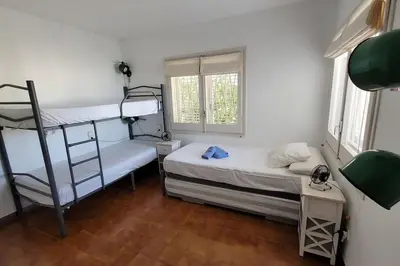 a bedroom with two bunk beds and a desk at Casa perfecta con vistas al Mar in San Pol de Mar