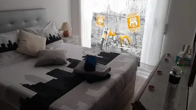 a bedroom with a black and white bed with pillows at STUDIO VILAFRANCA DEL PENEDES in Vilafranca del Penedès