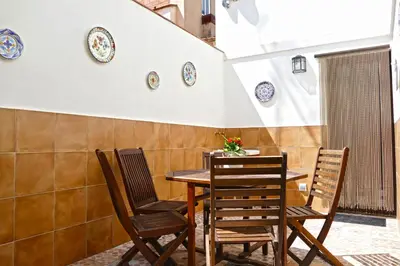 a table and chairs with plates on the wall at La Llar de la Kim, ideal familias in Arenys de Mar