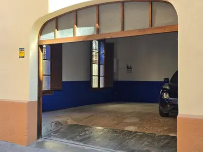 an open garage door with a car parked in it at La Llar de la Kim, ideal familias in Arenys de Mar
