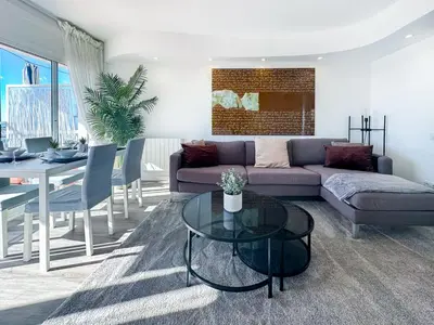 a living room with a couch and a table at Urban Waves by Hello Homes Sitges in Sitges