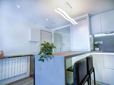 a kitchen with a counter with a potted plant at Urban Waves by Hello Homes Sitges in Sitges