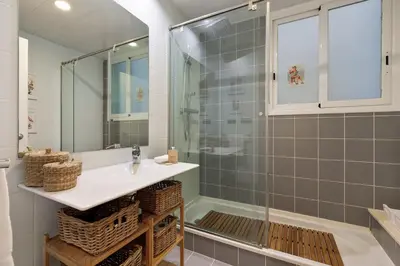 a bathroom with a sink and a shower at Frida by EnjoyApartments in Barcelona