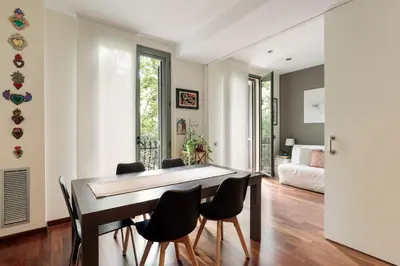 a dining room with a table and chairs at Frida by EnjoyApartments in Barcelona