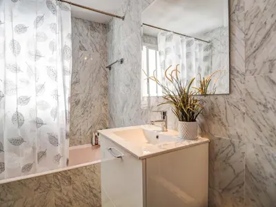 a bathroom with a sink and a shower at Llopart Apartment by Hello Homes Sitges in Sitges