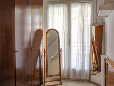 a mirror sitting in a room next to a door at Llopart Apartment by Hello Homes Sitges in Sitges