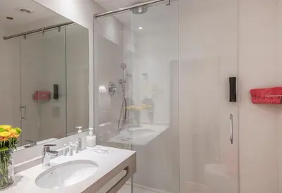 a bathroom with a glass shower and a sink at Hotel Continental Palacete in Barcelona