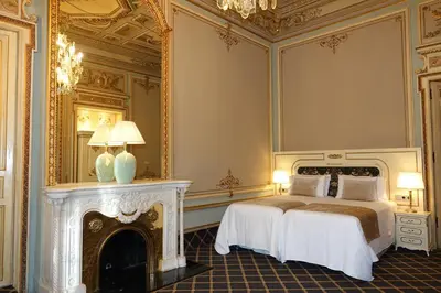 a bedroom with a bed with a fireplace and a mirror at Hotel Continental Palacete in Barcelona