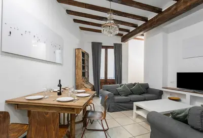 a living room with a table and a couch at Canela Homes BARCELONA GÒTIC in Barcelona