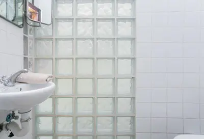 a bathroom with a glass shower backdoor with a sink at Canela Homes BARCELONA GÒTIC in Barcelona