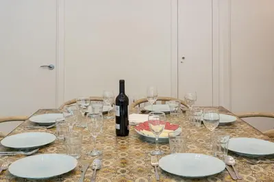 a table with a bottle of wine and glasses at Canela Homes BARCELONA ICÀRIA in Barcelona