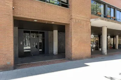 a brick building with a door in the side of it at Canela Homes BARCELONA ICÀRIA in Barcelona