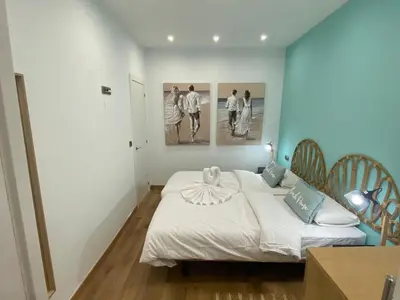 a bedroom with a bed and two pictures on the wall at Matarolux26 in Mataró