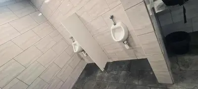 a bathroom with two urinals on the wall at COSY BOAT FLAT at BARCELONA BEACH in Barcelona