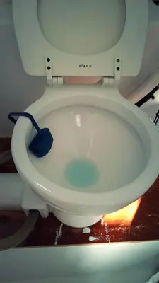 a toilet with a scrubber sitting on top of it at COSY BOAT FLAT at BARCELONA BEACH in Barcelona