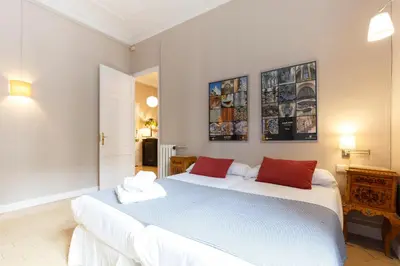 a bedroom with two beds and two pictures on the wall at AinB B&B Born-Via Laietana in Barcelona